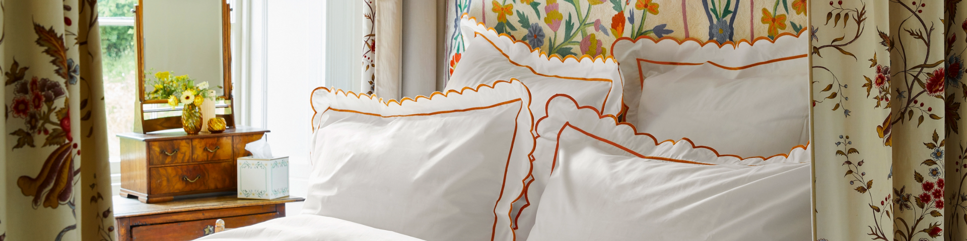 Scalloped bed linen on a made bed